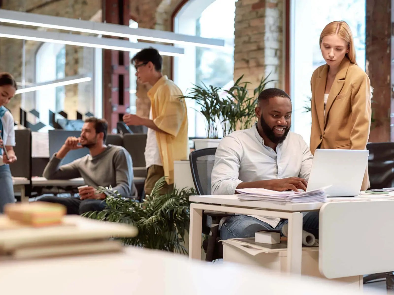 five people working in office