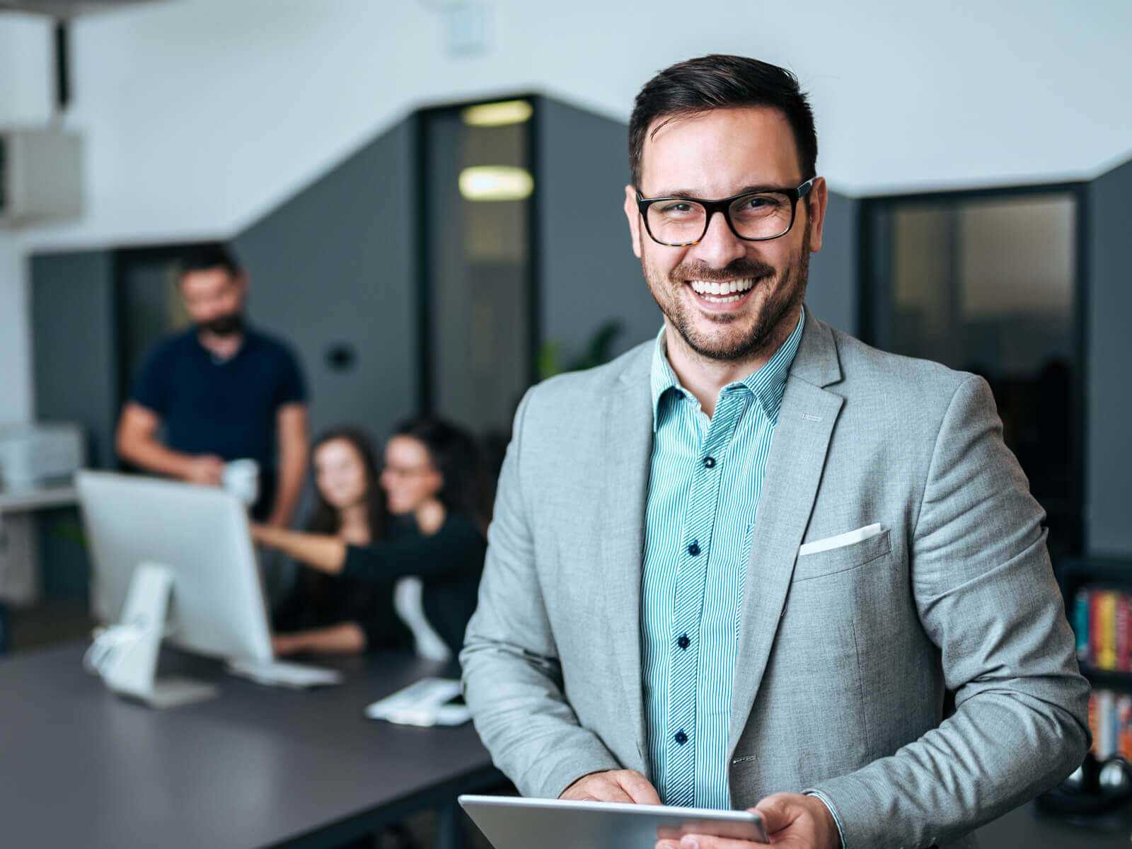 smiling man with laptop