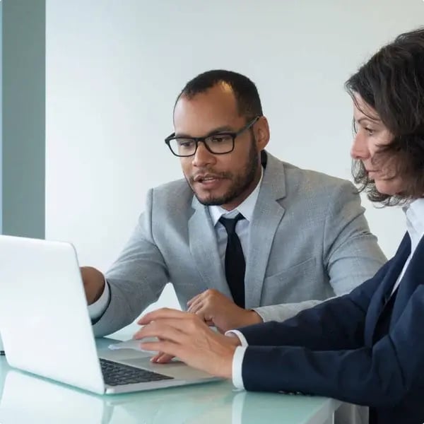 man on laptop with woman 